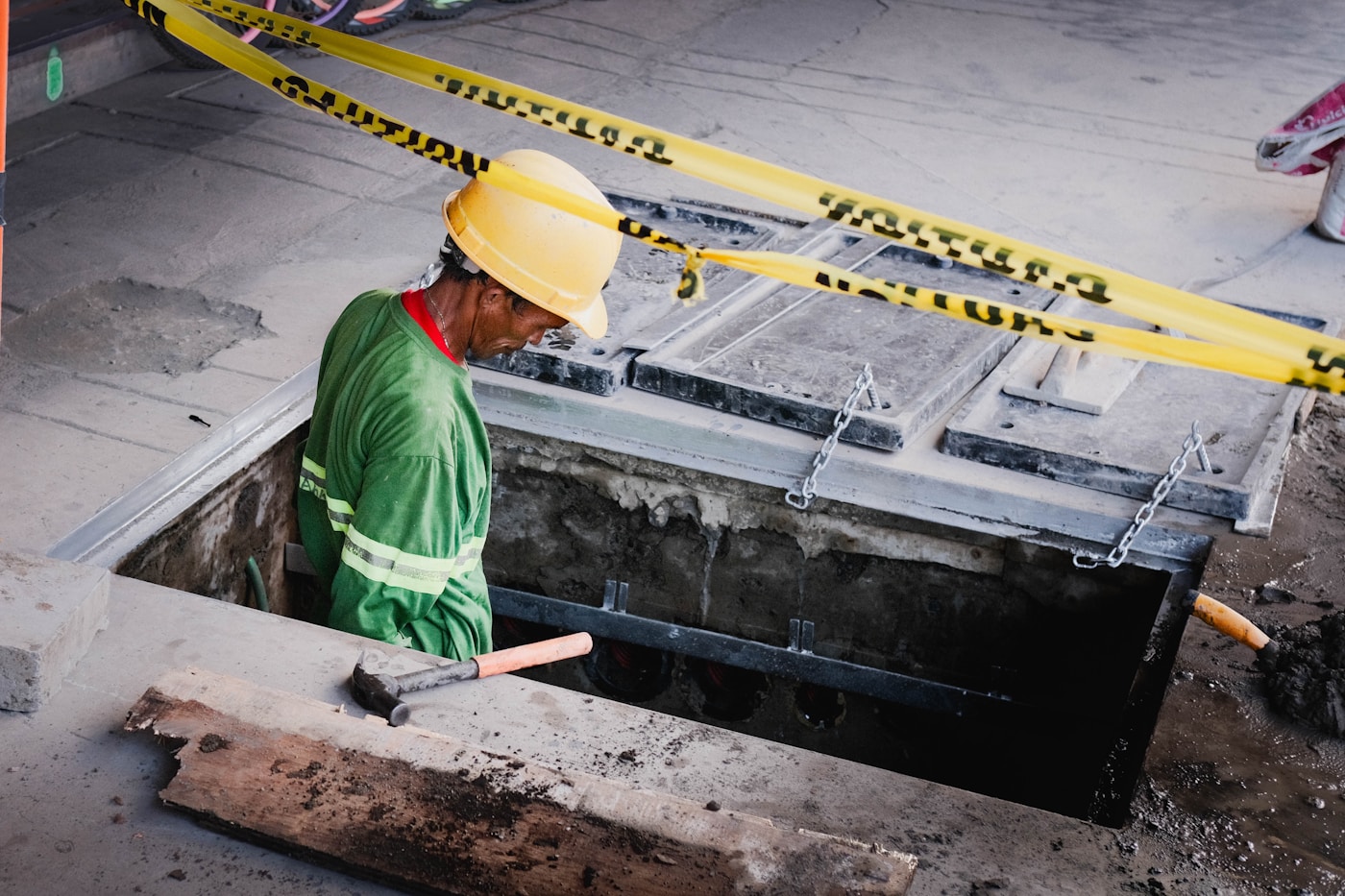 Engineer in safety equipment at an active construction site